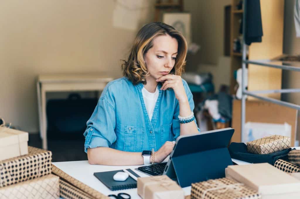 businesswoman thinking with concentration working at home on laptop